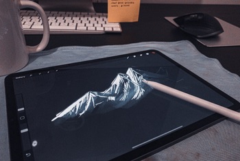 Designer sketching artwork on a tablet