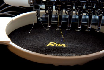 Embroidery machine stitching a name