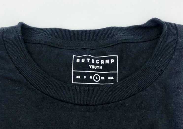 Custom printed neck label on a black tee